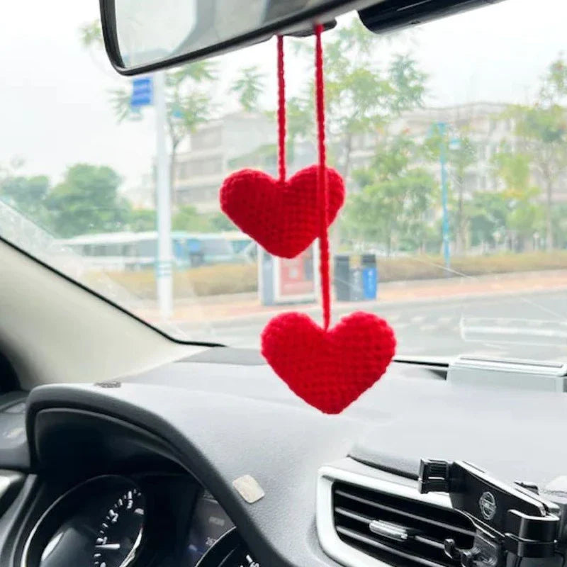 Charming knitted car plant decor with hanging white rope and green and white colour scheme
