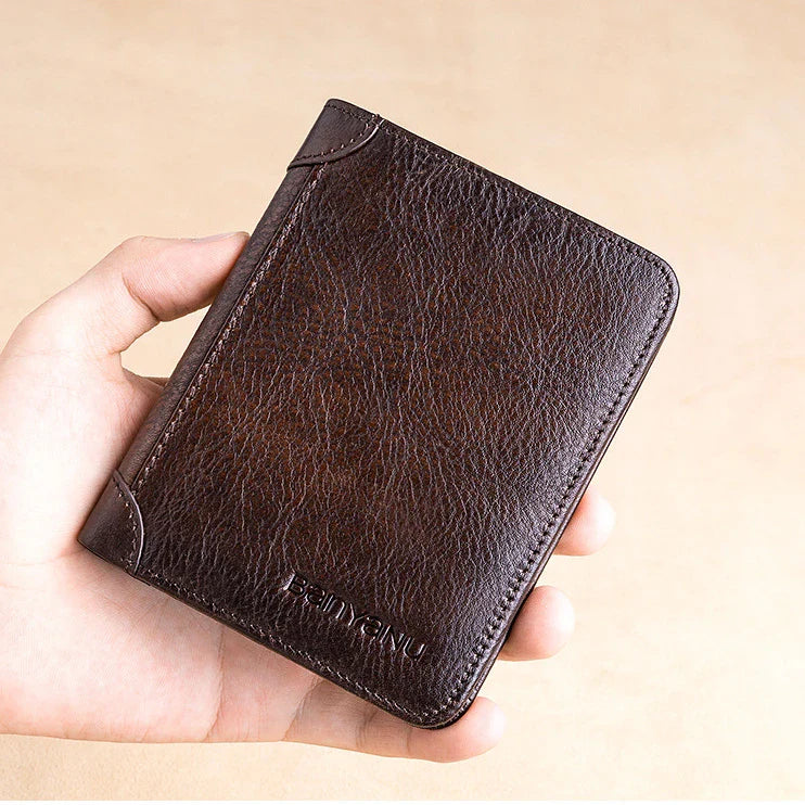 Premium men's short leather wallet with tri-fold design, made from top-grain cowhide leather for exceptional quality and style.