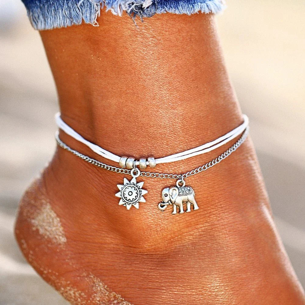 Elegant bohemian-style anklet with star and elephant charms in shimmering gold and silver tones