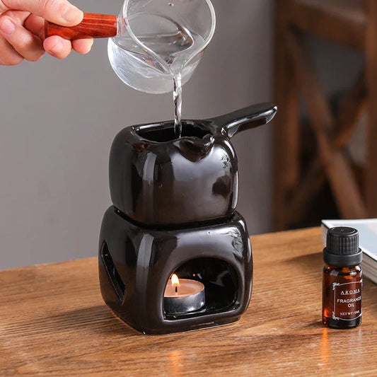 Elegant ceramic candle holder and tea warmer set in a classic square design with a wooden handle