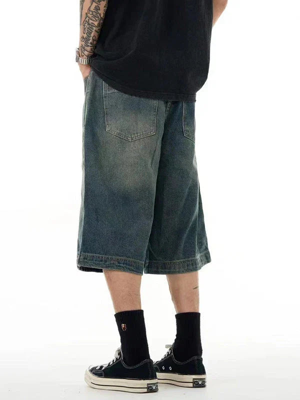 Relaxed-fit men's denim shorts in a vintage blue wash, featuring a wide-leg silhouette and adjustable waistband for maximum comfort.
