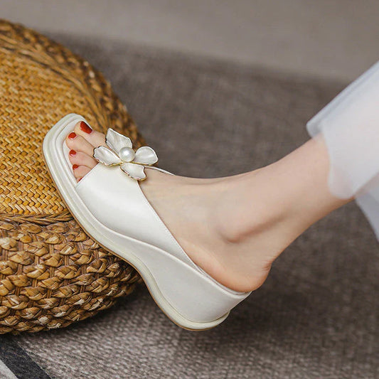 Elegant pearl flower wedge sandals in beige colour, featuring a thick, cushioned platform and adjustable straps for a comfortable fit.