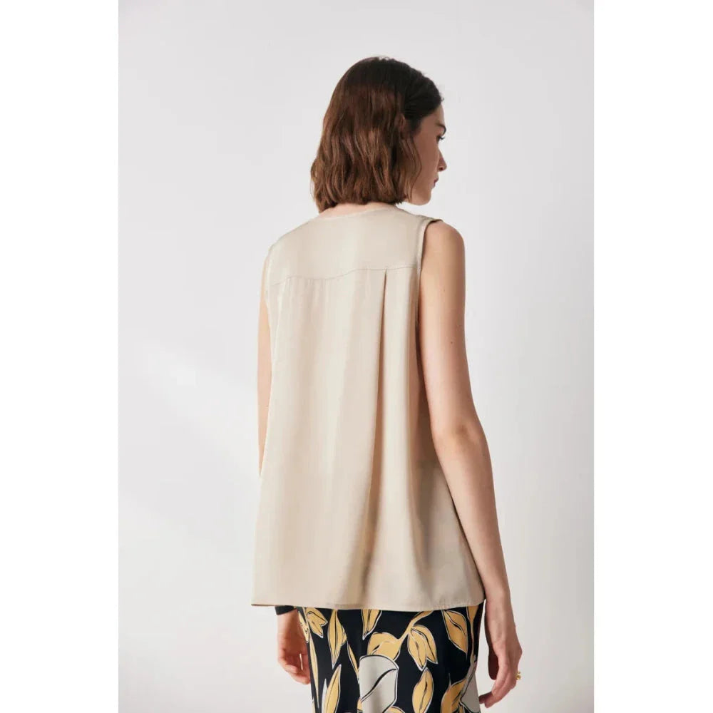 Elegant sleeveless silk blouse in a vibrant blue colour, designed for a sophisticated summer style
