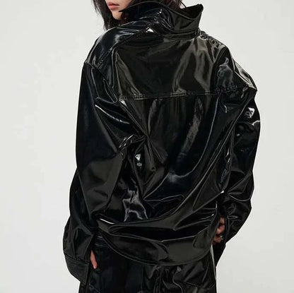 Elegant, fleece-lined PU leather jacket in a sleek, glossy black finish for timeless style and comfort