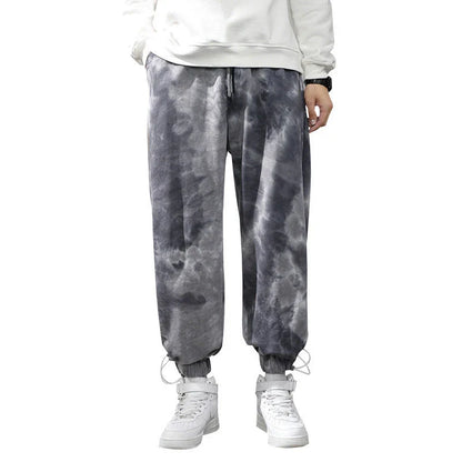 Stylish ankle-tied sweatpants in camouflage black, featuring an elasticated waistband, drawstring, and ankle ties for a relaxed yet refined look.