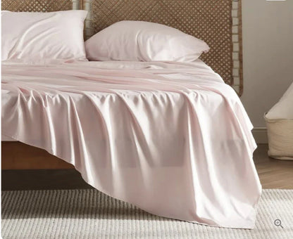 Premium bamboo fibre bed sheets in a classic solid purplish blue colour, featuring a four-piece set including a fitted sheet, flat sheet, and two pillowcases.