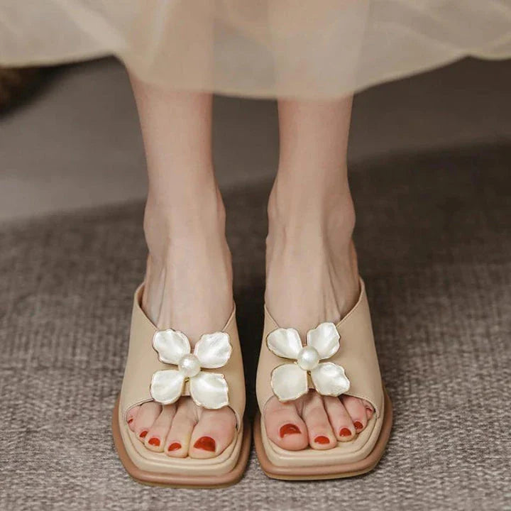 Elegant pearl flower wedge sandals in beige colour, featuring a thick, cushioned platform and adjustable straps for a comfortable fit.