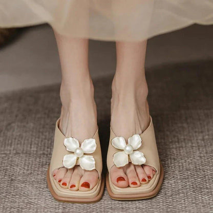 Elegant pearl flower wedge sandals in beige colour, featuring a thick, cushioned platform and adjustable straps for a comfortable fit.