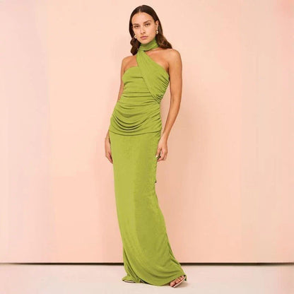 Elegant halter backless ankle-length bodycon dress in a solid colour, designed to flatter the figure and create a sophisticated, eye-catching look for formal events.