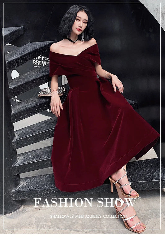 Off-shoulder wine red bridal dress with long, flowing skirt and tight waist for a sophisticated, elegant look