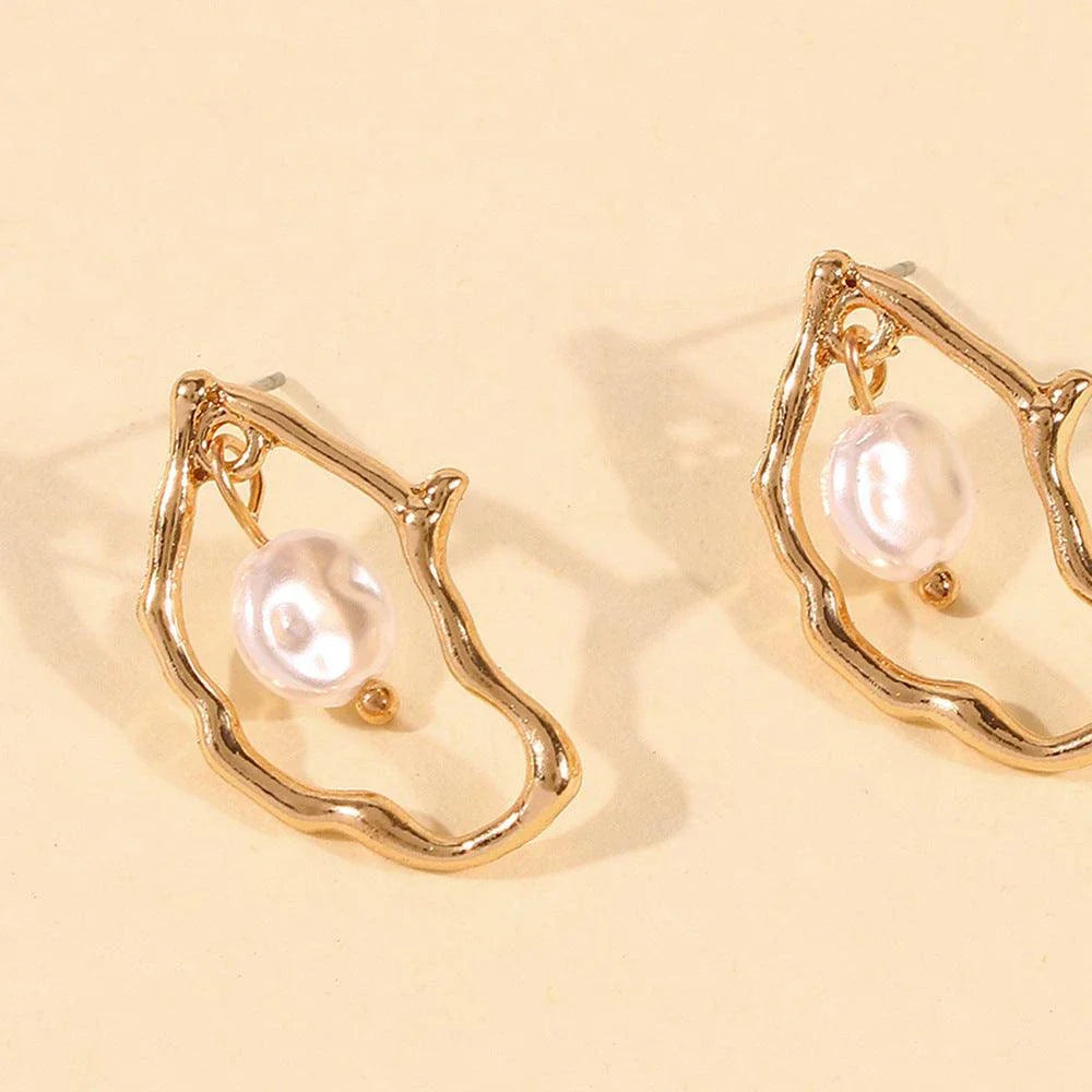 Irregular pearl earrings in a gold colour, featuring a unique and stylish design for versatile wear