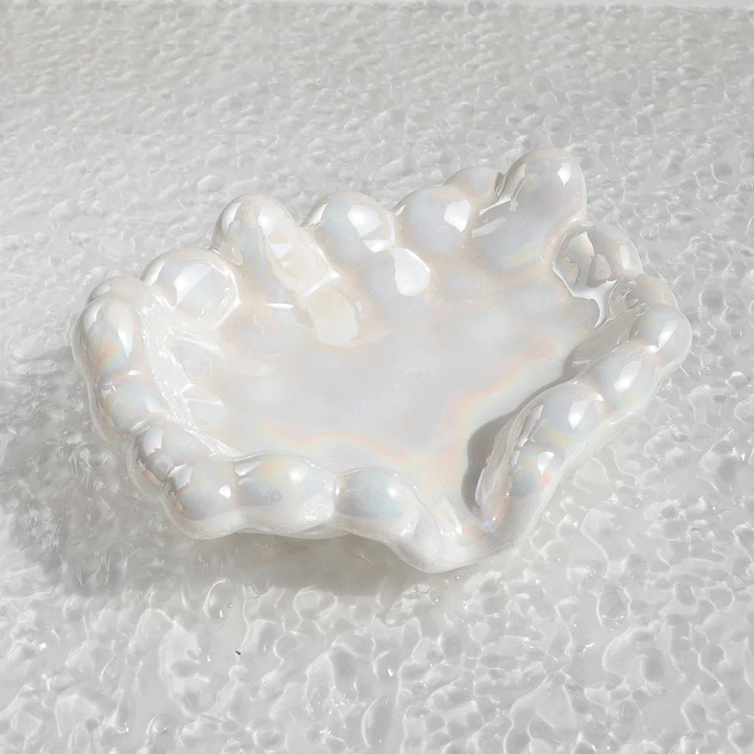 A ceramic soap dish with a whimsical cloud design, perfect for elevating your bathroom decor.