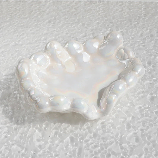 A ceramic soap dish with a whimsical cloud design, perfect for elevating your bathroom decor.