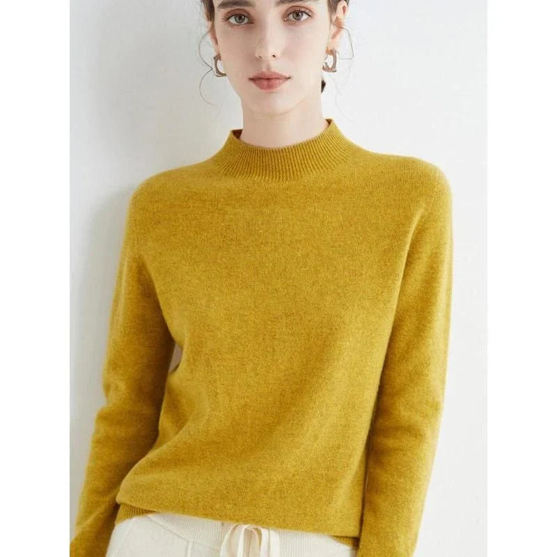 A woman wearing a luxurious Merino wool mock-neck jumper in a stylish autumnal outfit