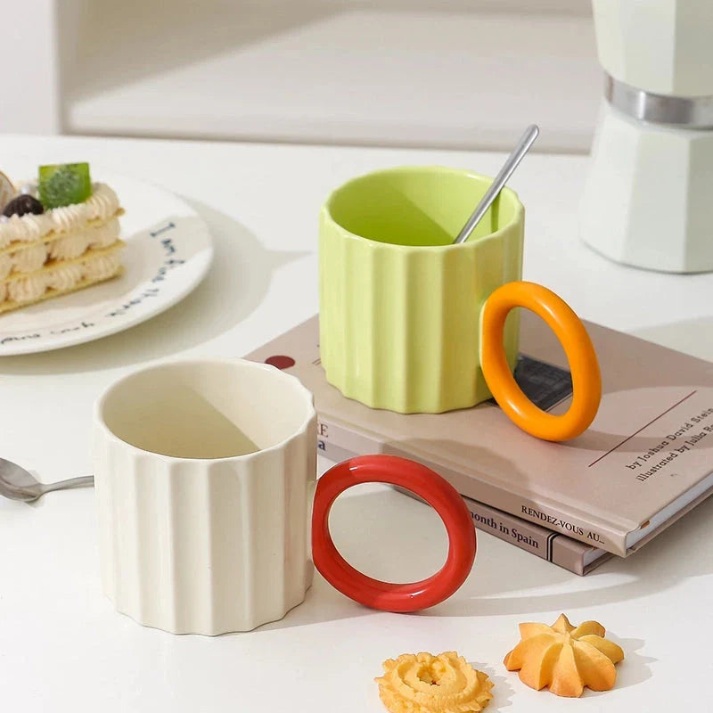 Japanese-style ceramic coffee mug with a unique ripple handle design, perfect for hot and cold beverages