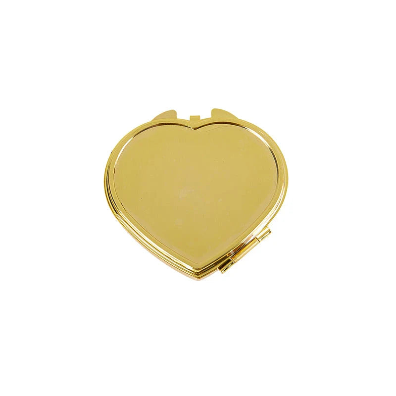 Elegant heart-shaped metal pill box with mirror for organized storage and convenient touch-ups