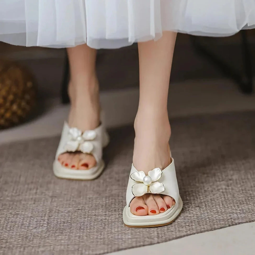Elegant pearl flower wedge sandals in beige colour, featuring a thick, cushioned platform and adjustable straps for a comfortable fit.