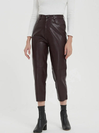Pair of high-waisted, ankle-length faux leather trousers in a classic brown colour
