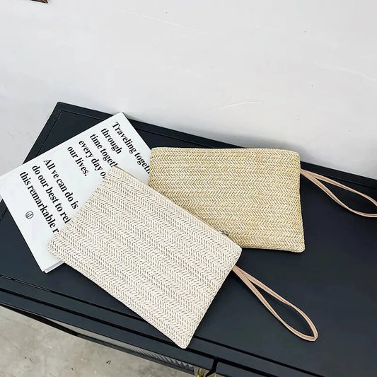 A natural straw-woven clutch with a zipper closure, perfect for summer outings in the UK.
