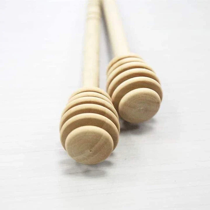 Handcrafted wooden honey spoon with a natural beeswax finish, showcasing the elegant design and timeless British craftsmanship.