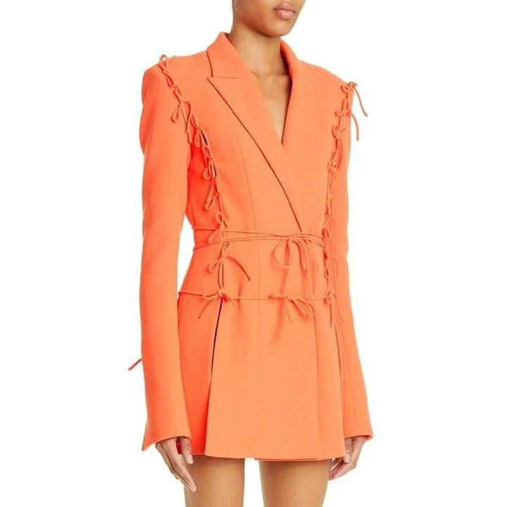 A sophisticated notched collar blazer with an elegant bow detail, perfect for professional and casual wear.