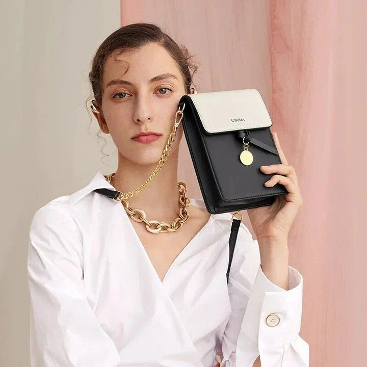 Stylish black leather crossbody phone bag with tassel accent, offering secure storage and versatile design for everyday use.