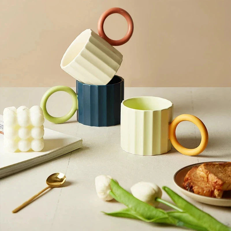 Japanese-style ceramic coffee mug with a unique ripple handle design, perfect for hot and cold beverages