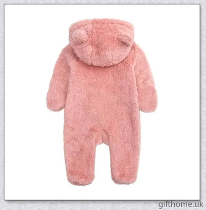 Adorable baby wearing a cosy hooded jumpsuit in blue, pink, or apricot colour