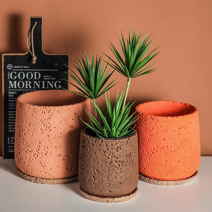 A modern, perforated cement bonsai planter in a Nordic-inspired design, available in various sizes and colours.
