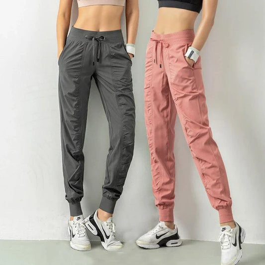 Premium women's sports trousers with drawstring waist and pockets, made of high-quality nylon fabric for comfort and versatility.