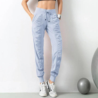 Premium women's sports trousers with drawstring waist and pockets, made of high-quality nylon fabric for comfort and versatility.