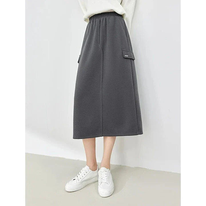 Elegant dark grey midi skirt with subtle sequin detailing, suitable for autumn and winter wear
