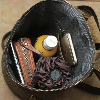 A premium Crazy Horse leather backpack with a classic bucket-style design and retro-inspired flair, perfect for the discerning urban adventurer.