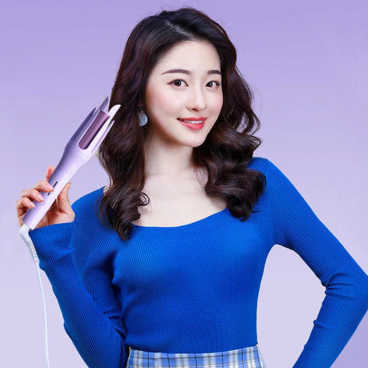 Auto-Rotating Ceramic Hair Styler in Pink, with adjustable temperature settings and dual voltage compatibility for worldwide use