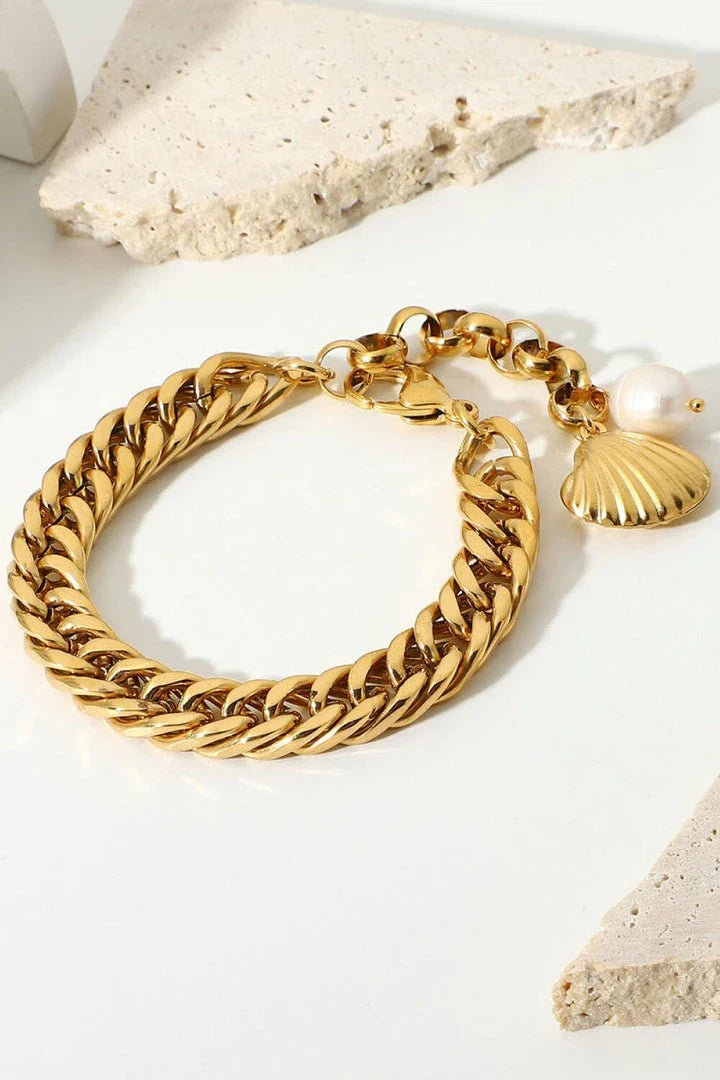 Elegant 18-carat gold-plated curb chain bracelet with a delicate pearl accent, showcasing premium British craftsmanship