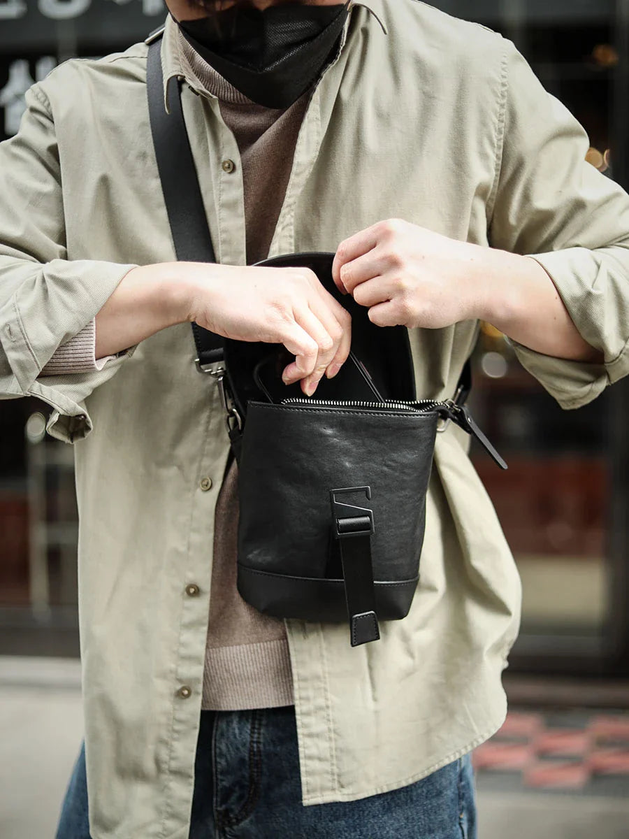 Premium cowhide leather shoulder sling bag with one-shoulder design and oblique paneling for modern British style