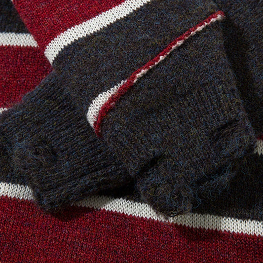 A cosy and stylish jumper featuring a patchwork design with contrasting stripes in a classic British colour palette.