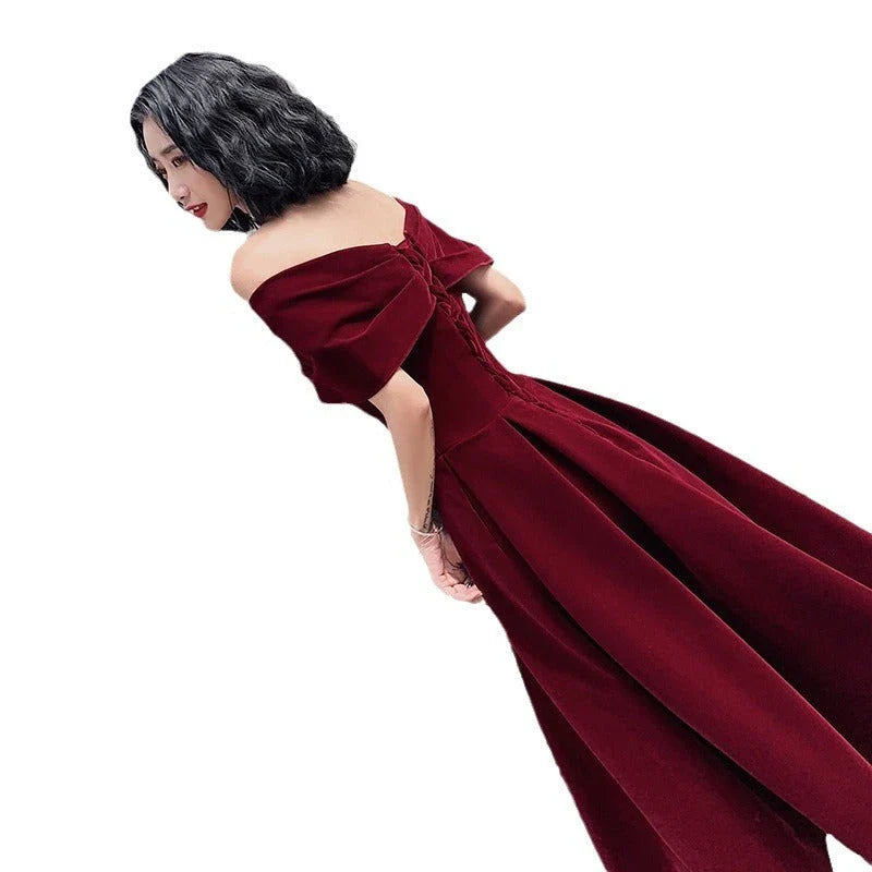 Off-shoulder wine red bridal dress with long, flowing skirt and tight waist for a sophisticated, elegant look