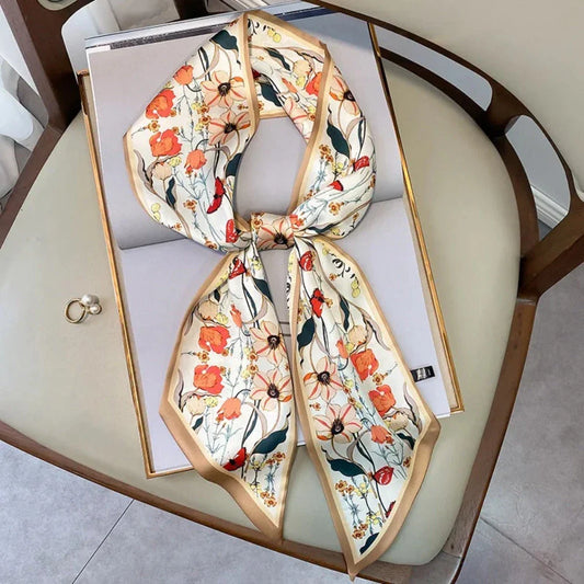 A vibrant floral-patterned silk-feel long scarf that can be worn as a neck accessory, hair tie, or wrist adornment for all occasions.