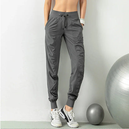 Premium women's sports trousers with drawstring waist and pockets, made of high-quality nylon fabric for comfort and versatility.