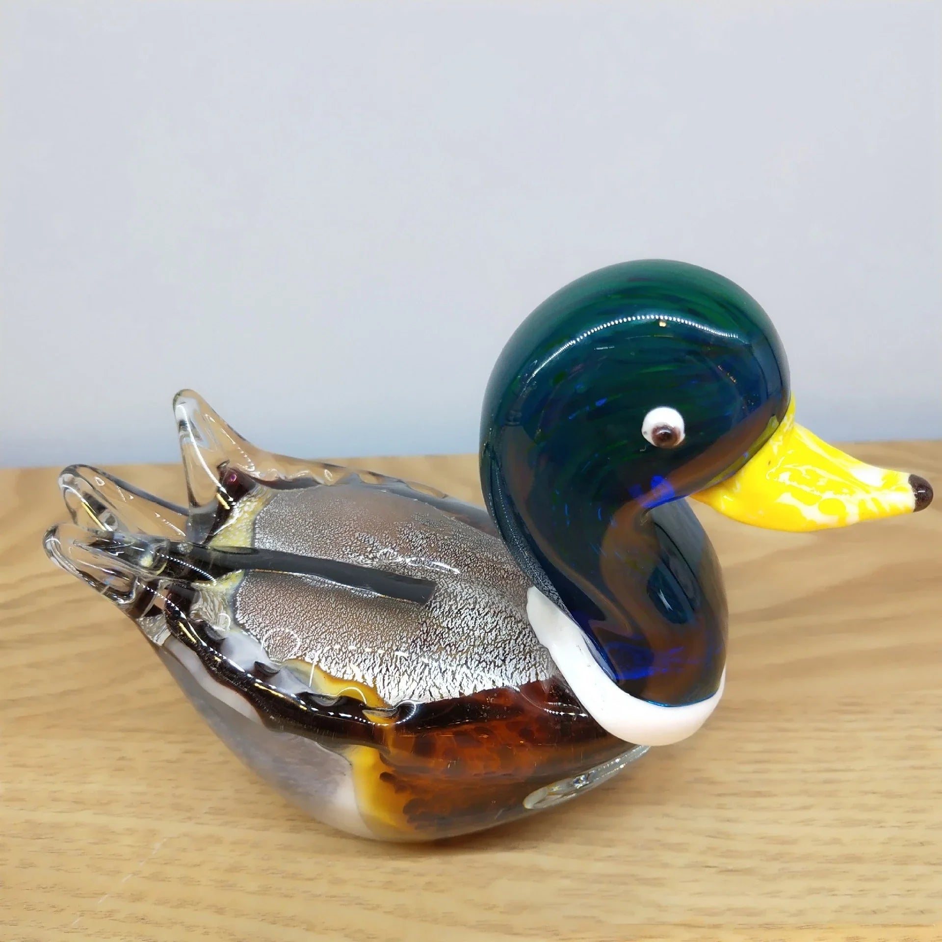 Handcrafted glass ornament in the shape of a Mandarin duck with vibrant colours and intricate details