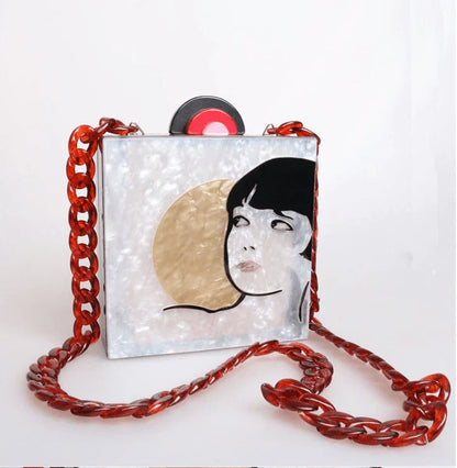 Antique hand-stitched acrylic crossbody bag in a vintage style with a yellow chain strap, perfect for evening events or everyday use.