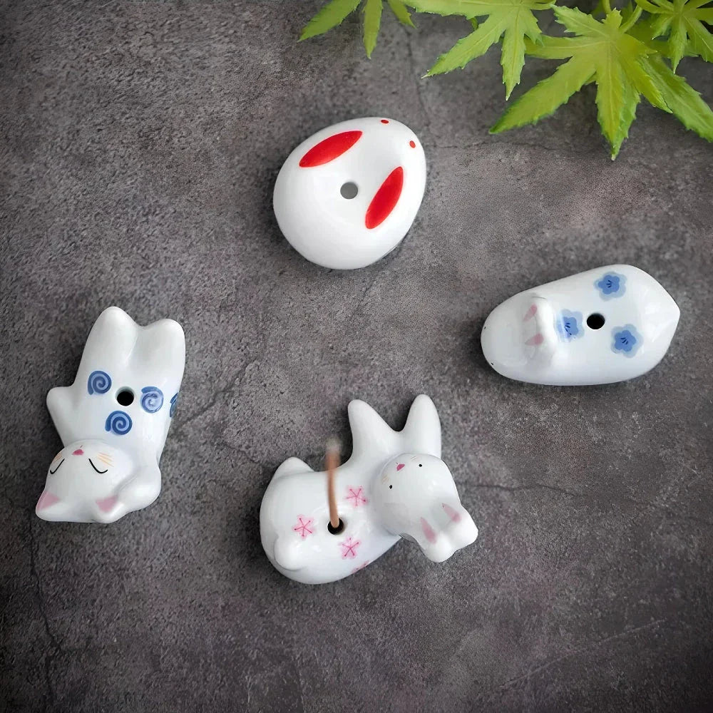 Charming Japanese-style ceramic incense holder with a playful rabbit and kitten design, perfect for creating a relaxing atmosphere in any room.