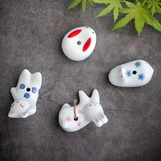 Charming Japanese-style ceramic incense holder with a playful rabbit and kitten design, perfect for creating a relaxing atmosphere in any room.