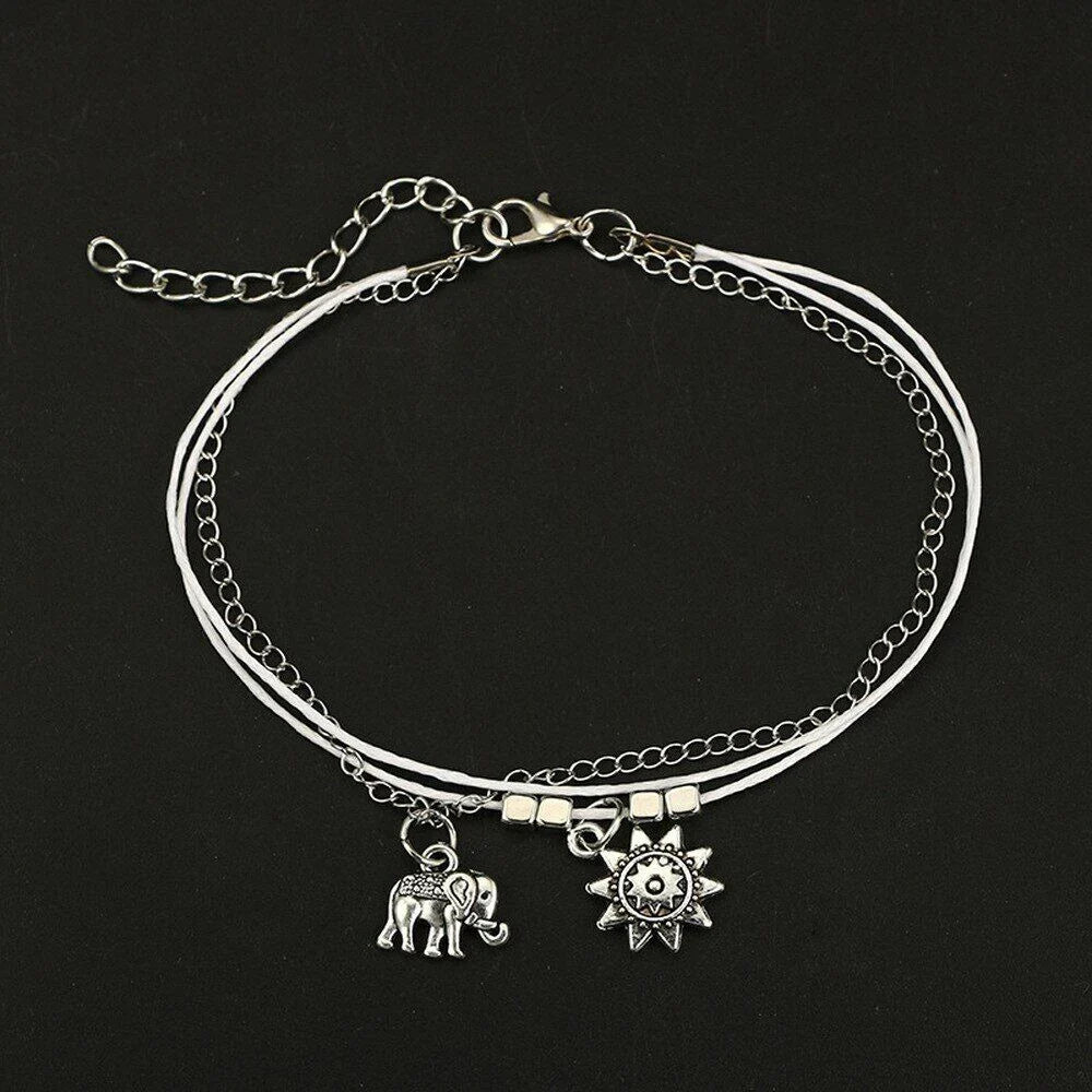 Elegant bohemian-style anklet with star and elephant charms in shimmering gold and silver tones