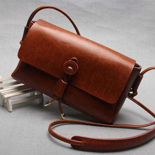 Premium leather crossbody bag in a sleek, horizontal square design with subtle car stitching details