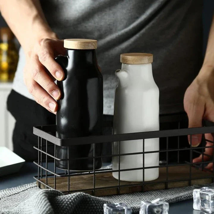 Premium black ceramic oil dispenser with a sleek and modern design, perfect for drizzling oils, vinegars, and sauces in the kitchen.