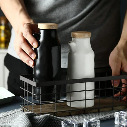 Premium black ceramic oil dispenser with a sleek and modern design, perfect for drizzling oils, vinegars, and sauces in the kitchen.