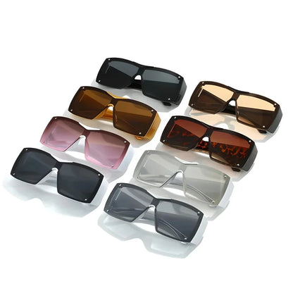 Oversized square sunglasses with black lenses and a durable plastic frame, offering UV400 protection and adaptive photochromic technology.