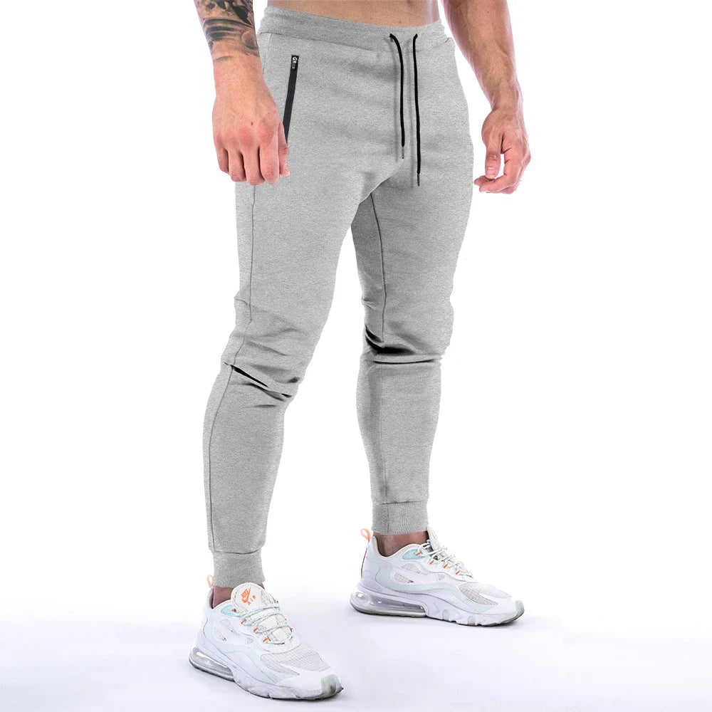 Premium athleisure trousers for stylish British men, featuring a refined sports-inspired design, breathable cotton construction, and a sleek, slim-fit silhouette.